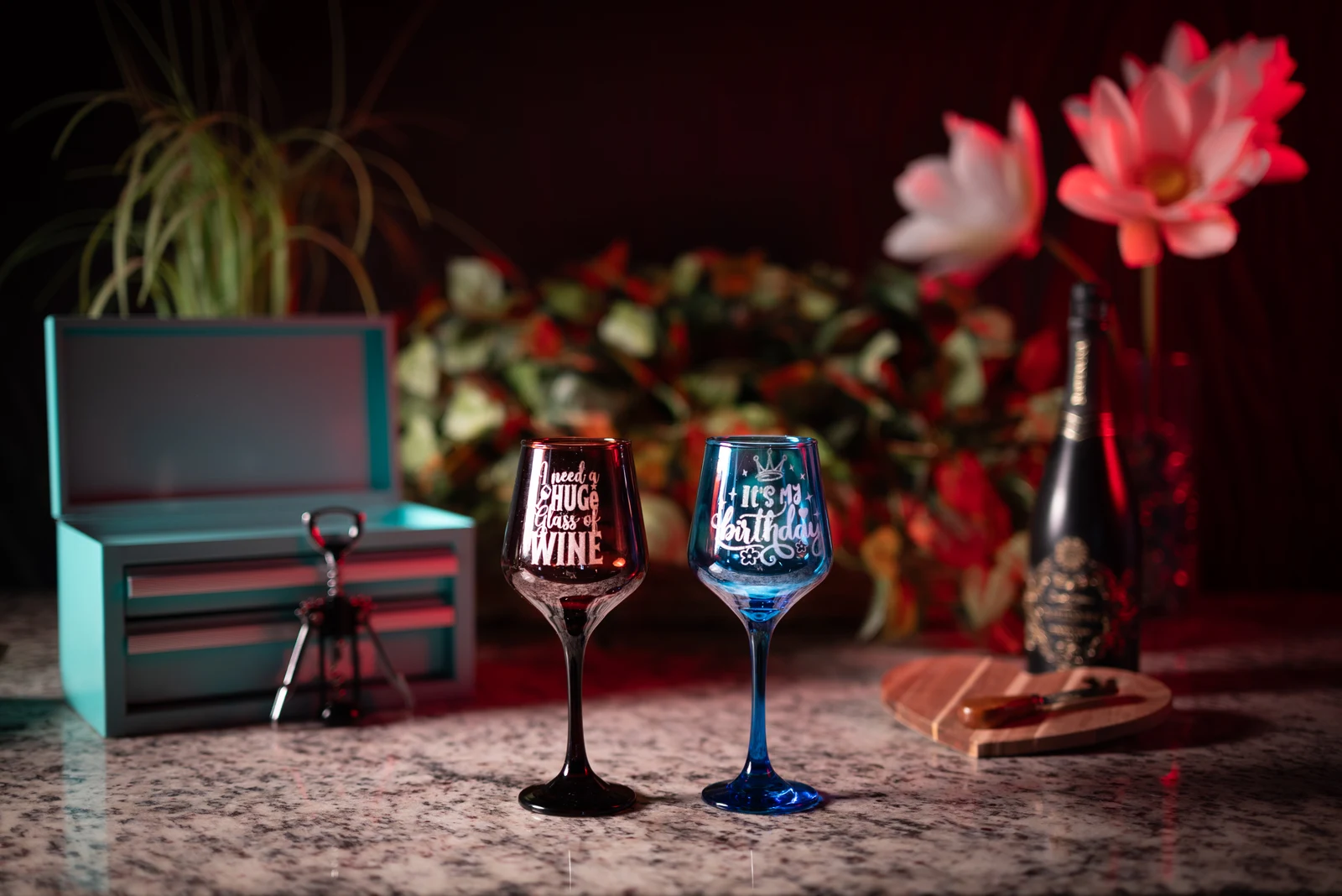 Photographed red and blue engraved wine glasses with a wine gift set
